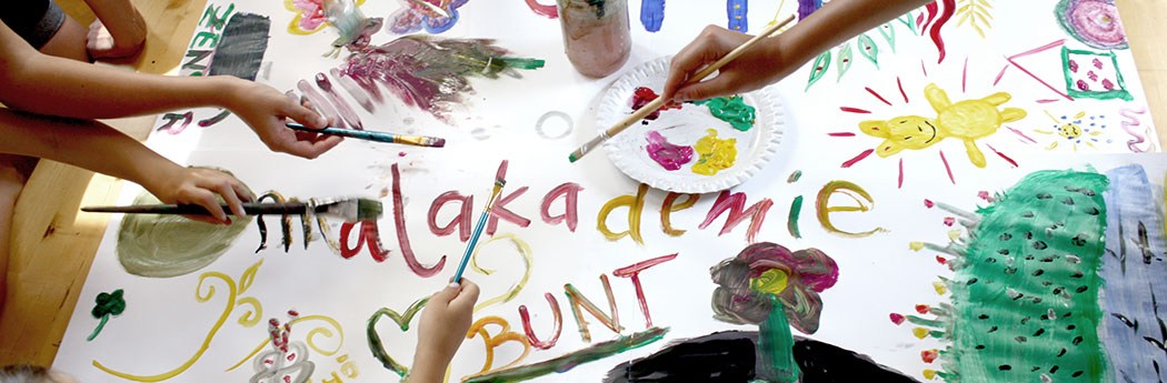 Die Kinder im Malkurs nutzen Pinsel, Stifte und Acrylfarben und gestalten ein buntes Bild.